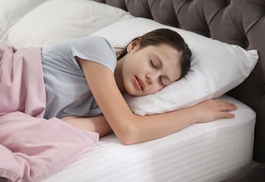 Photo of Beautiful little girl sleeping in bed at home