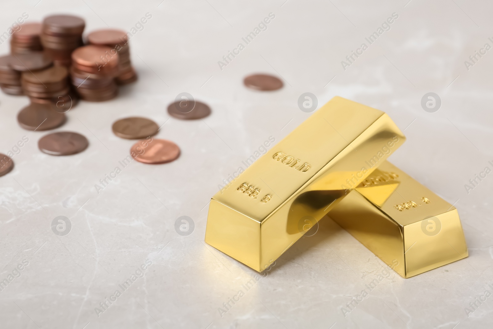 Photo of Gold bars and coins on table. Space for text