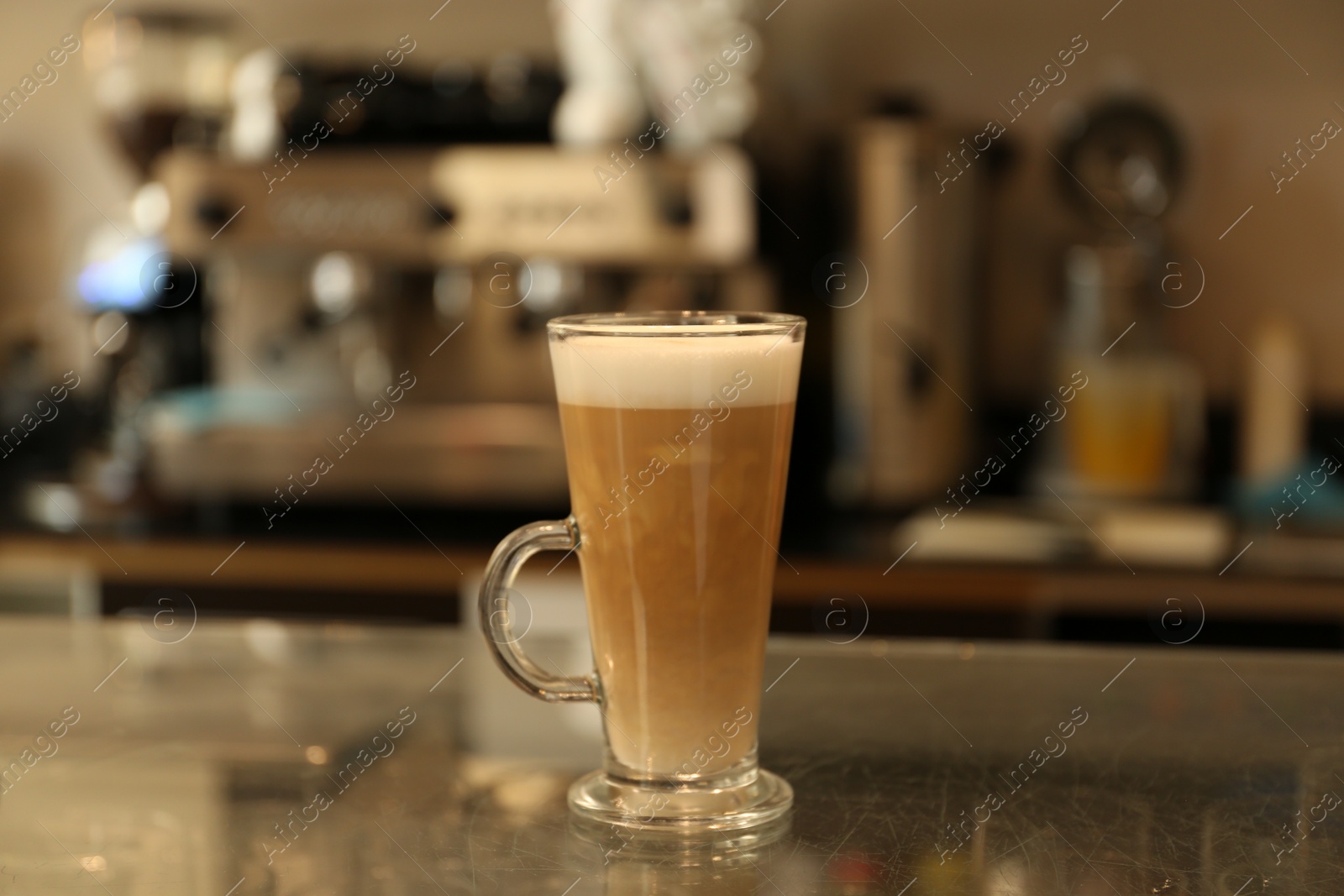 Photo of Glass with delicious coffee on countertop in cafe indoors