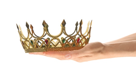 Photo of Woman holding beautiful golden crown on white background, closeup. Fantasy item