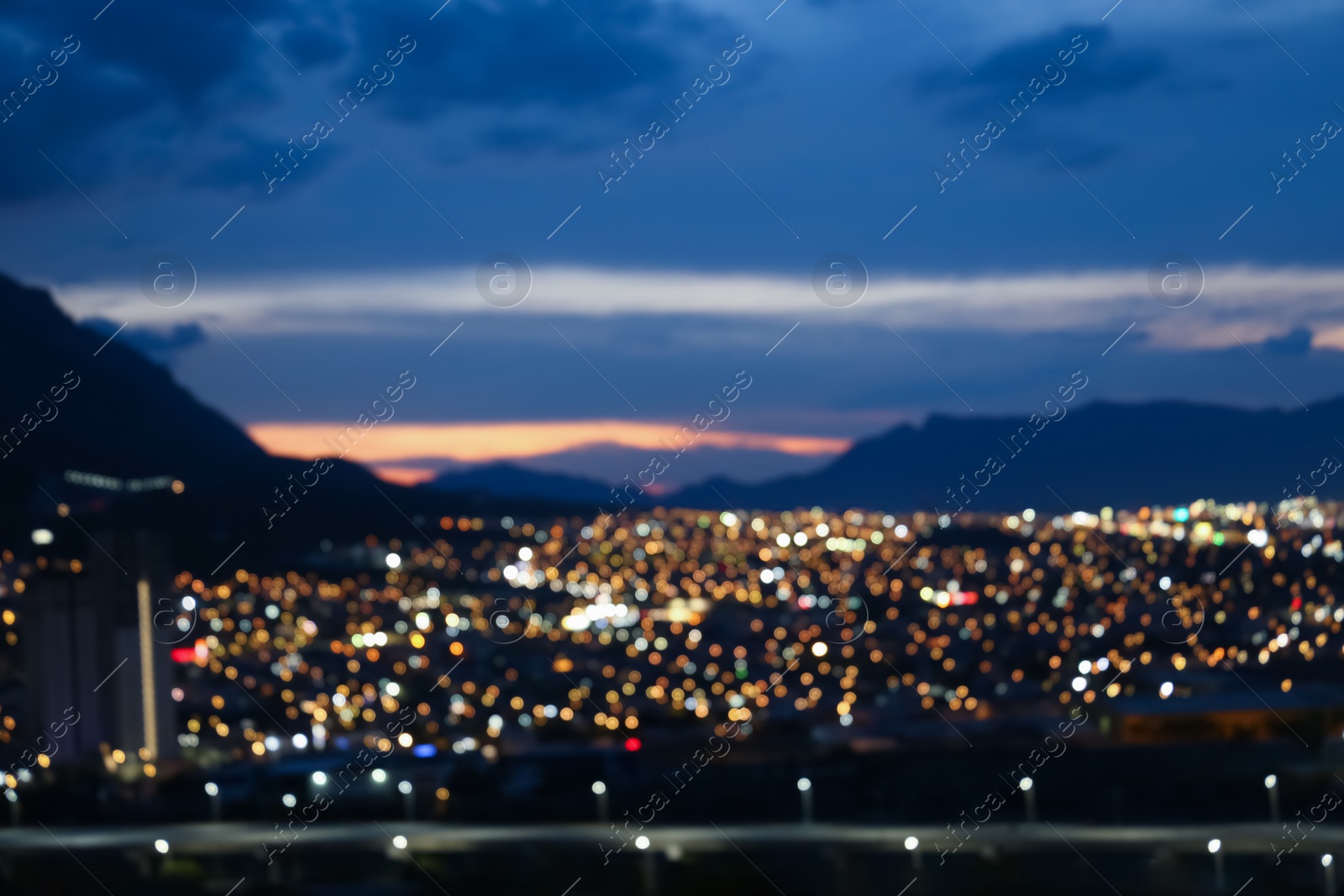 Photo of Blurred view of cityscape and mountains, bokeh effect