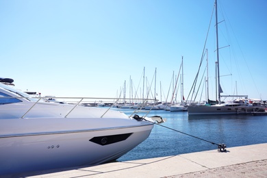 Photo of Modern boats near pier and clear blue sky