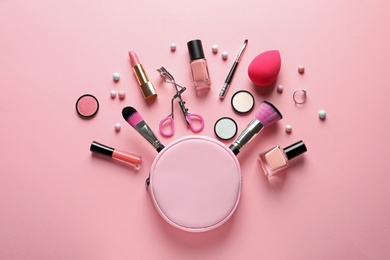 Photo of Flat lay composition with products for decorative makeup on pastel pink background