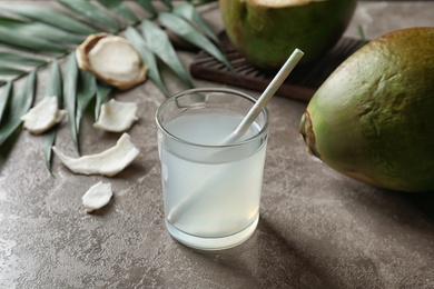 Photo of Glass of fresh coconut water on table