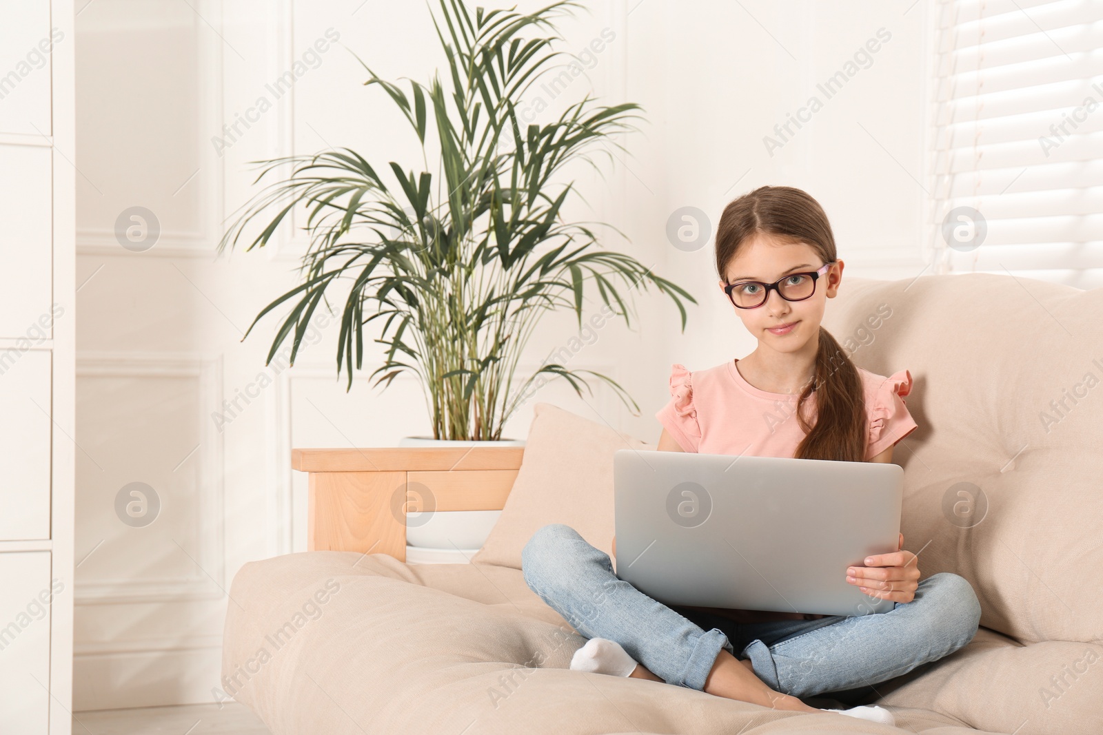 Photo of Girl with laptop on sofa at home