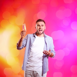 Photo of Portrait of happy man with champagne in glass on color background