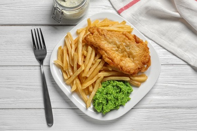 Photo of Plate with British traditional fish and potato chips on wooden background, top view