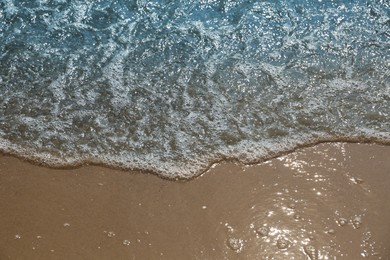 Sea waves rolling onto beautiful sandy beach