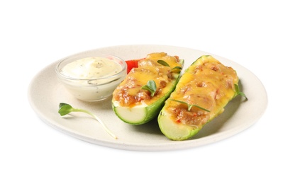 Photo of Baked stuffed zucchinis with sauce on white background