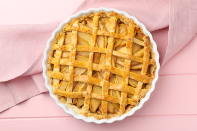 Photo of Tasty homemade quince pie on pink wooden table, top view