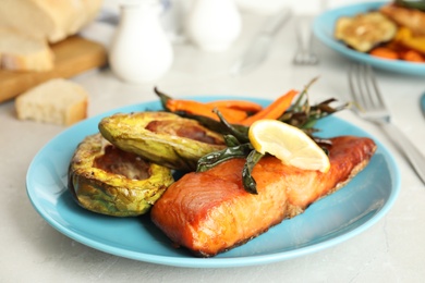 Photo of Delicious cooked salmon and vegetables on grey table, closeup. Healthy meals from air fryer