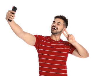 Photo of Happy young man taking selfie on white background