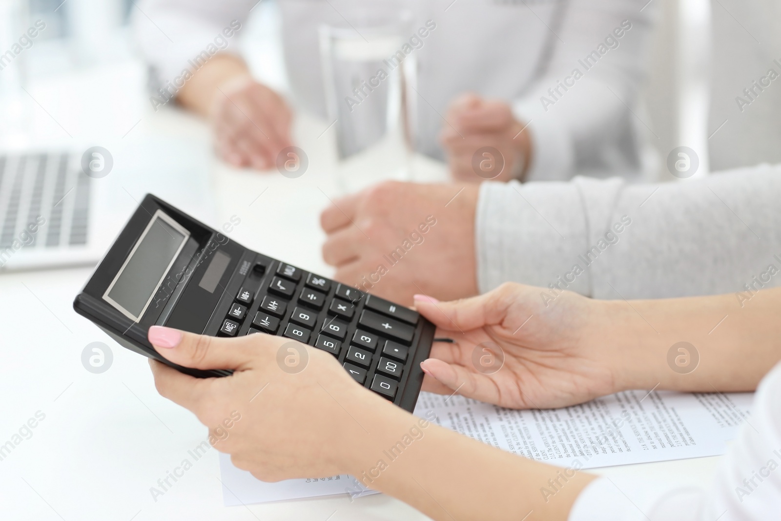 Photo of Woman counselling mature couple about their pension in office, closeup