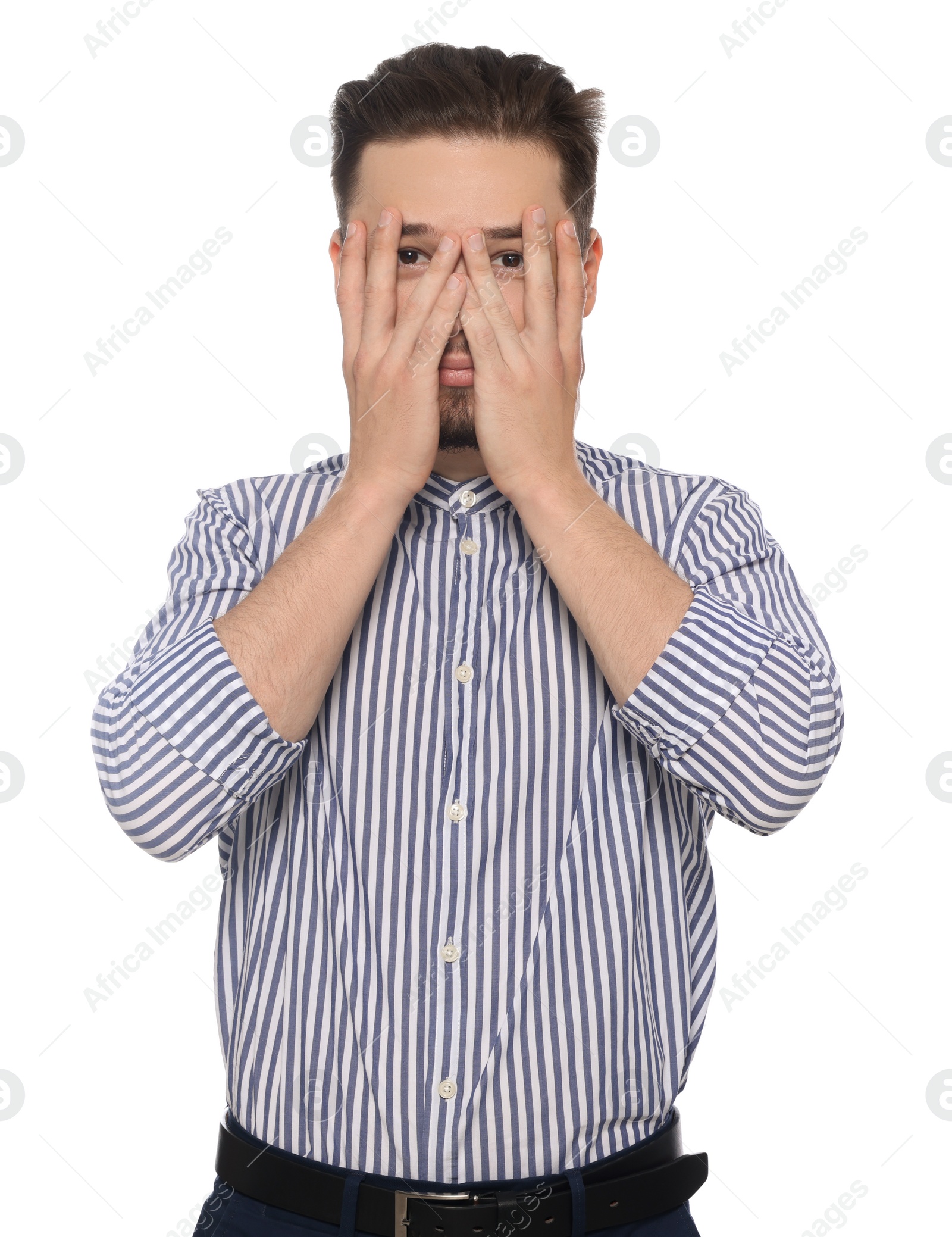 Photo of Embarrassed man covering face with hands on white background