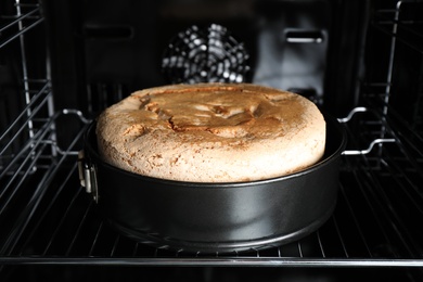 Photo of Delicious fresh homemade cake on rack in oven