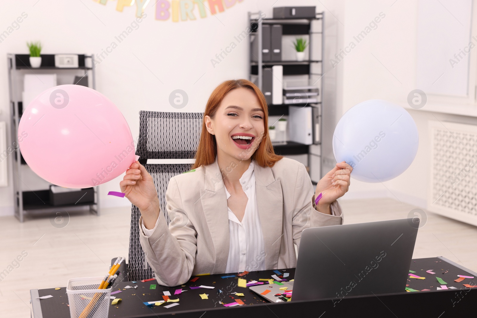 Photo of Young woman having fun during office party at workplace