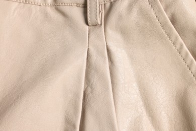 Photo of Beige natural leather with seams as background, top view