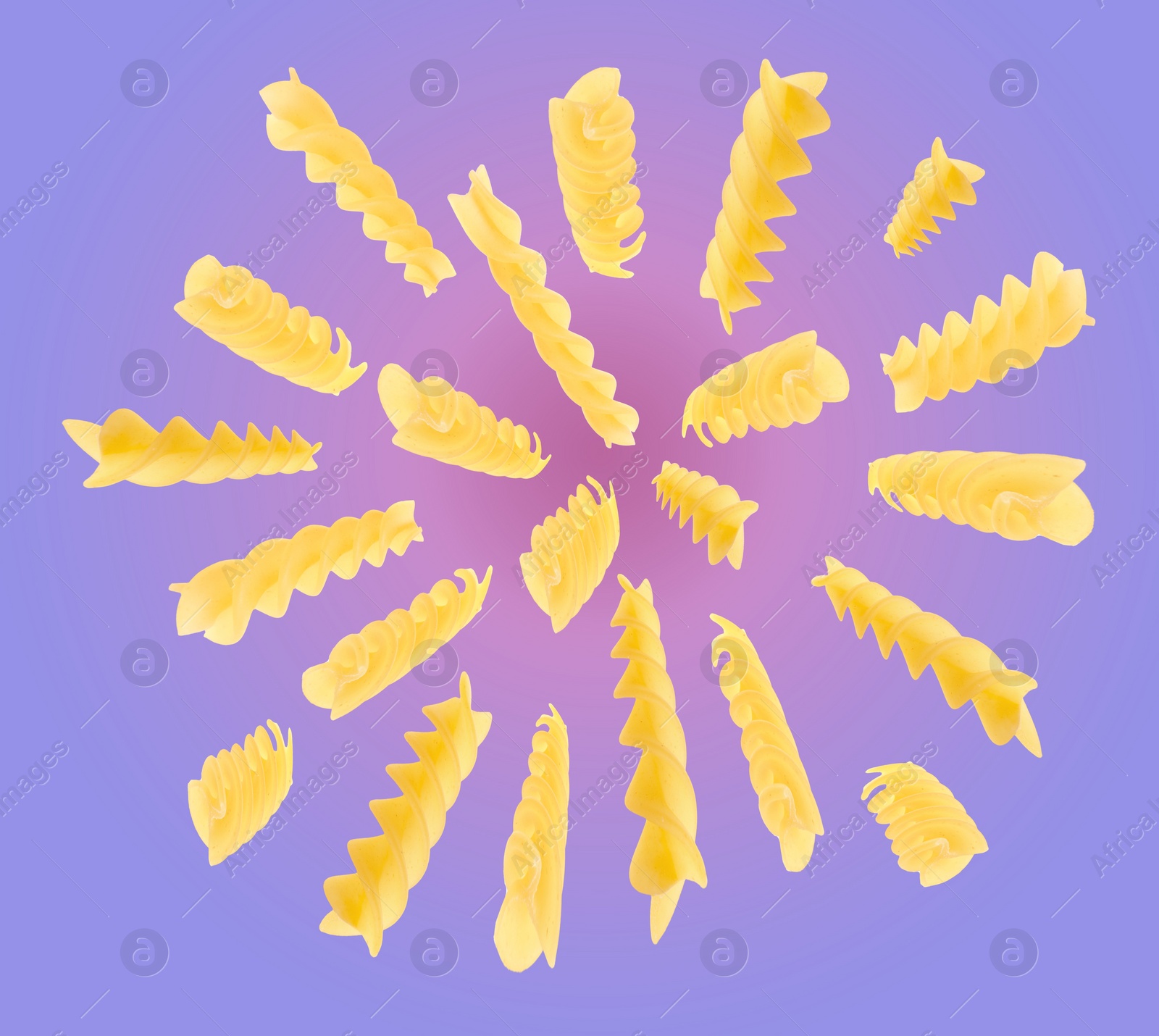 Image of Raw fusilli pasta flying on color background