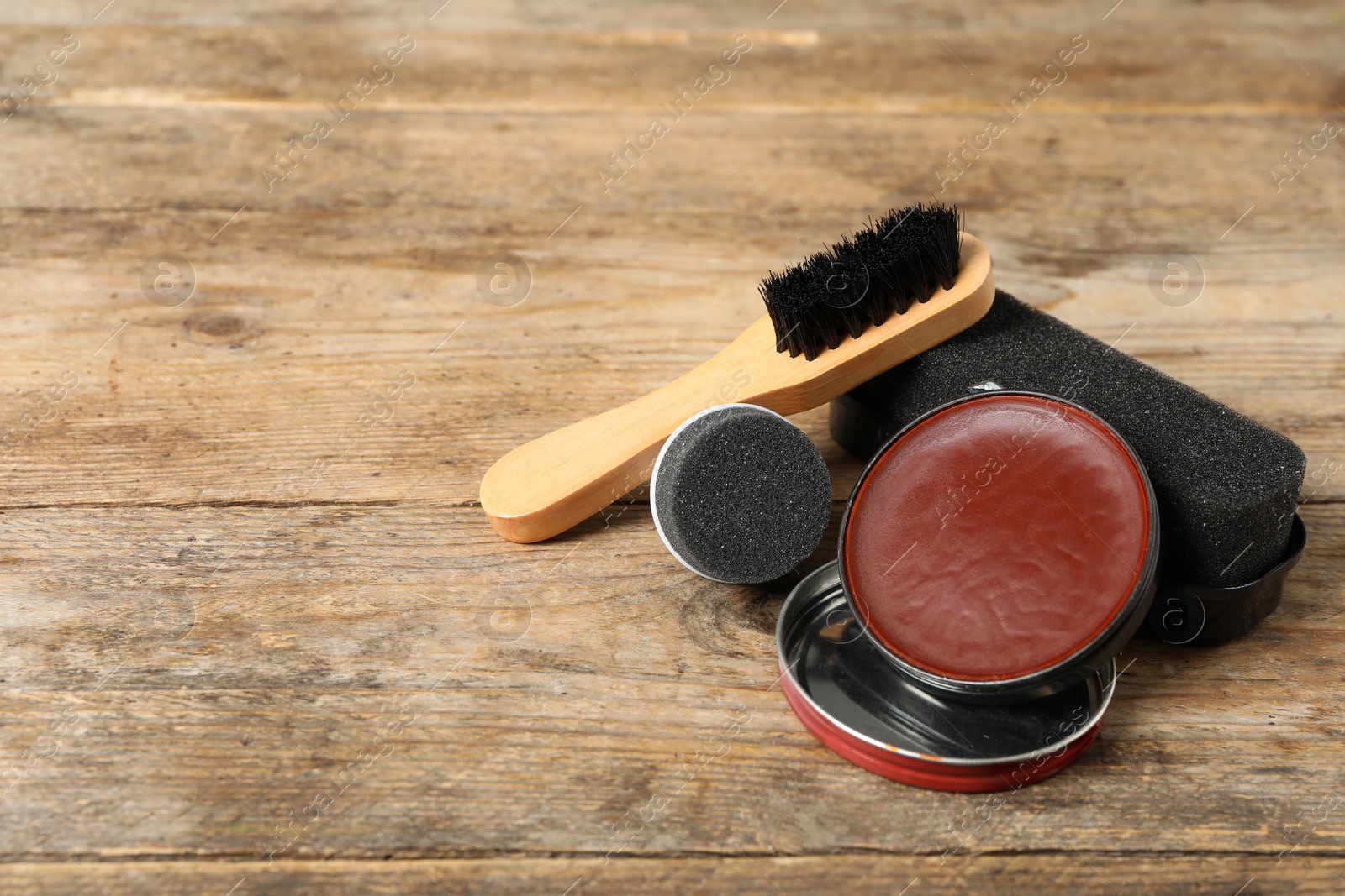 Photo of Composition with shoe care accessories on wooden background. Space for text