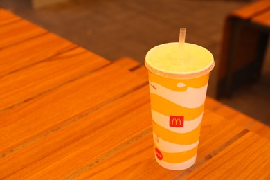 MYKOLAIV, UKRAINE - AUGUST 11, 2021: Cold McDonald's drink on table in cafe. Space for text