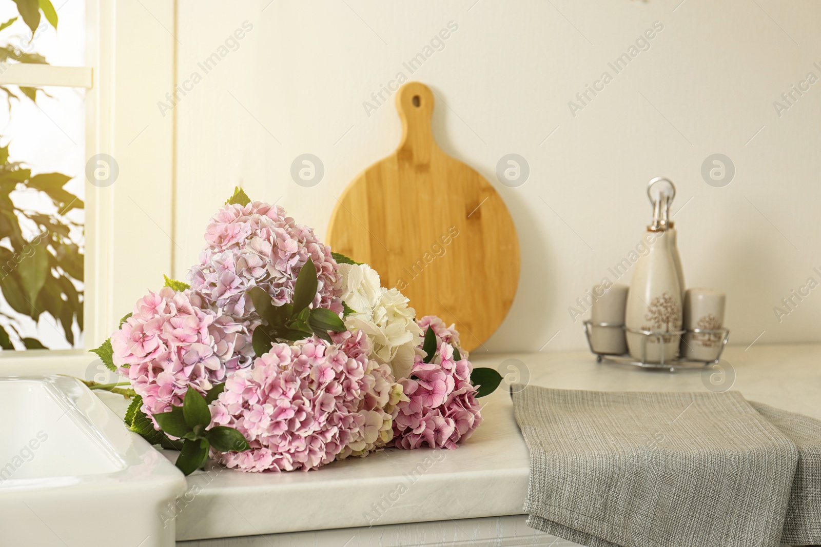Photo of Beautiful hydrangea flowers bouquet on light countertop