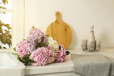 Photo of Beautiful hydrangea flowers bouquet on light countertop