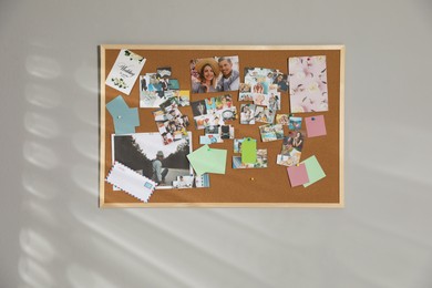 Photo of Vision board with different photos representing dreams on grey wall