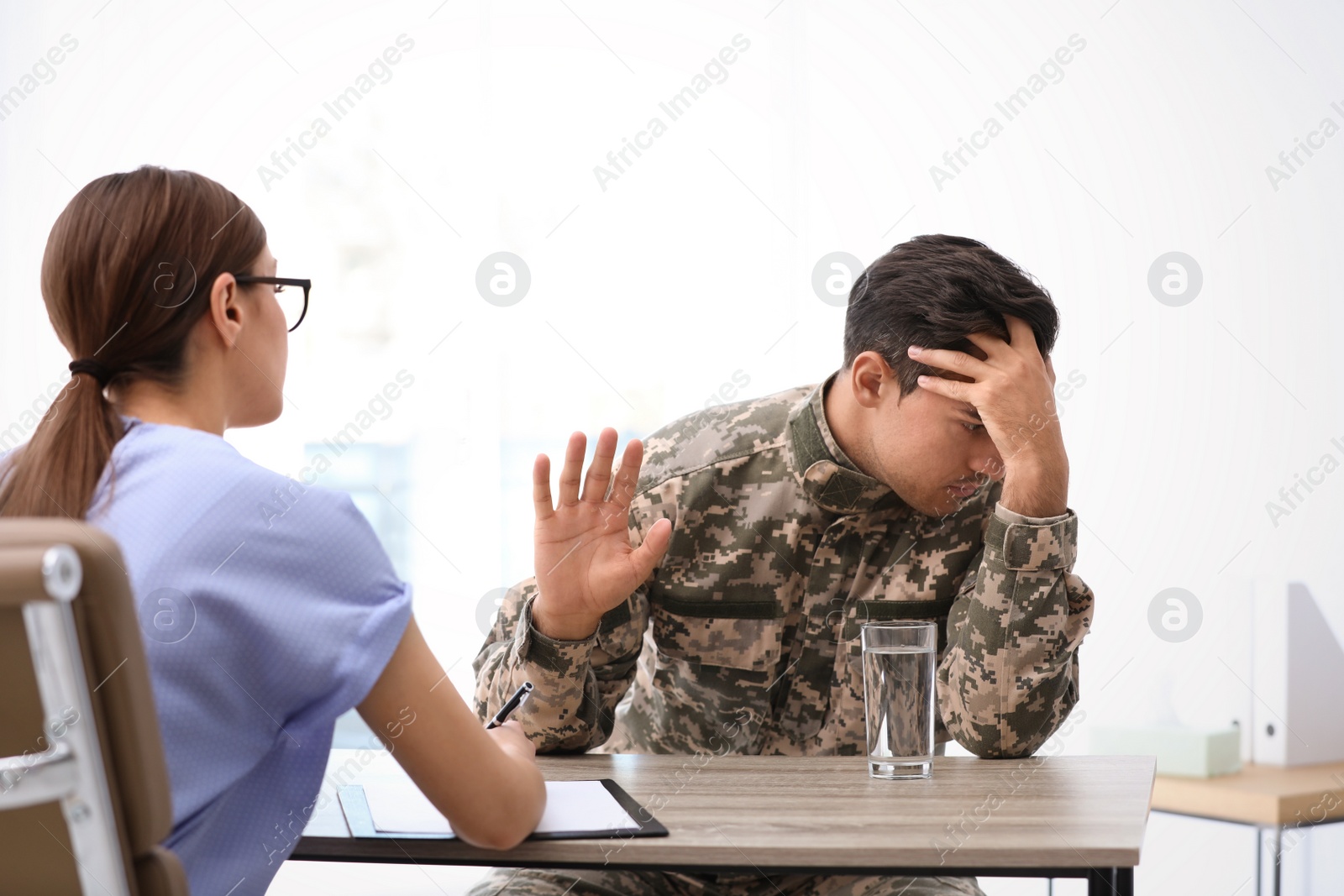 Photo of Psychotherapist working with male military officer in office