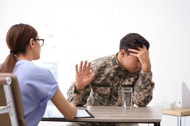 Psychotherapist working with male military officer in office