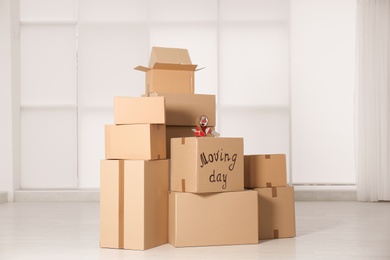 Photo of Pile of moving boxes in empty room