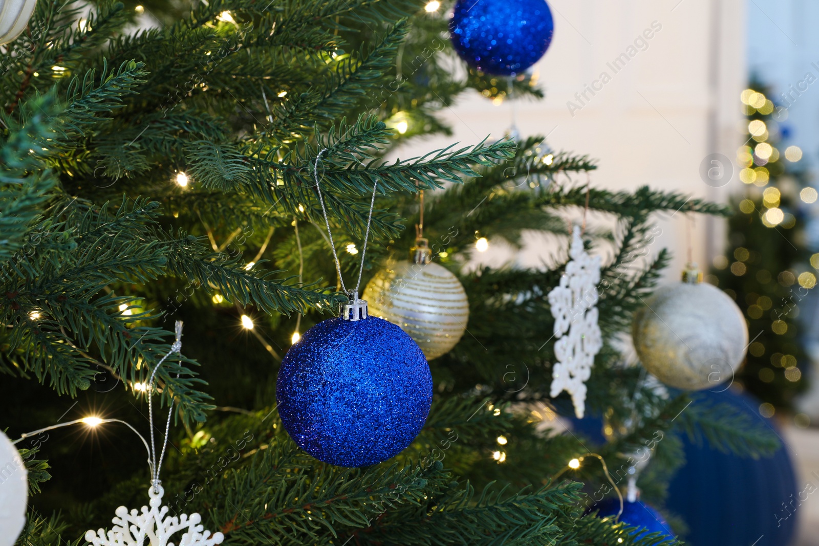 Photo of Beautifully decorated Christmas tree with baubles, closeup