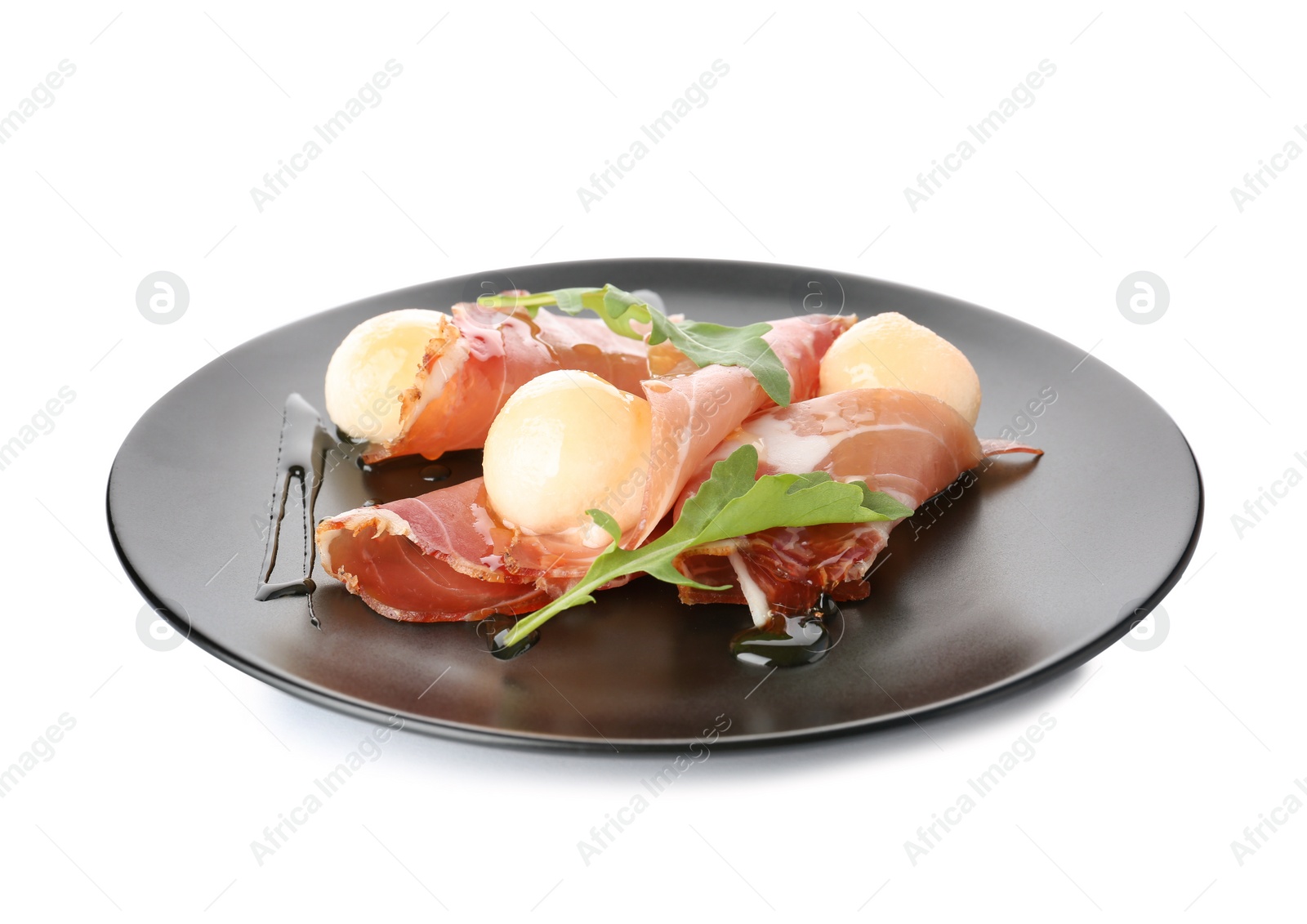 Photo of Plate with melon balls and prosciutto on white background