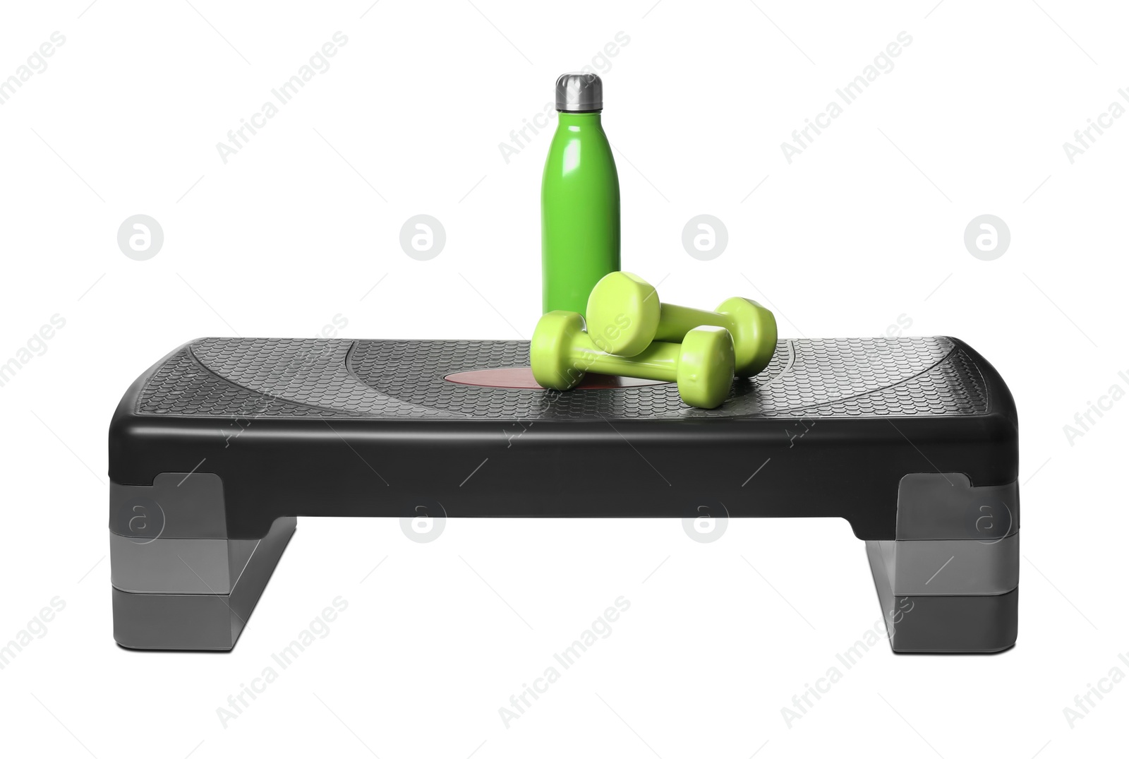 Photo of Step platform, dumbbells and bottle on white background. Sports equipment