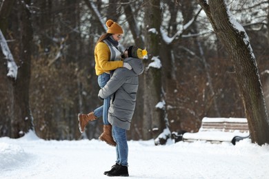 Beautiful happy couple outdoors on winter day. Space for text