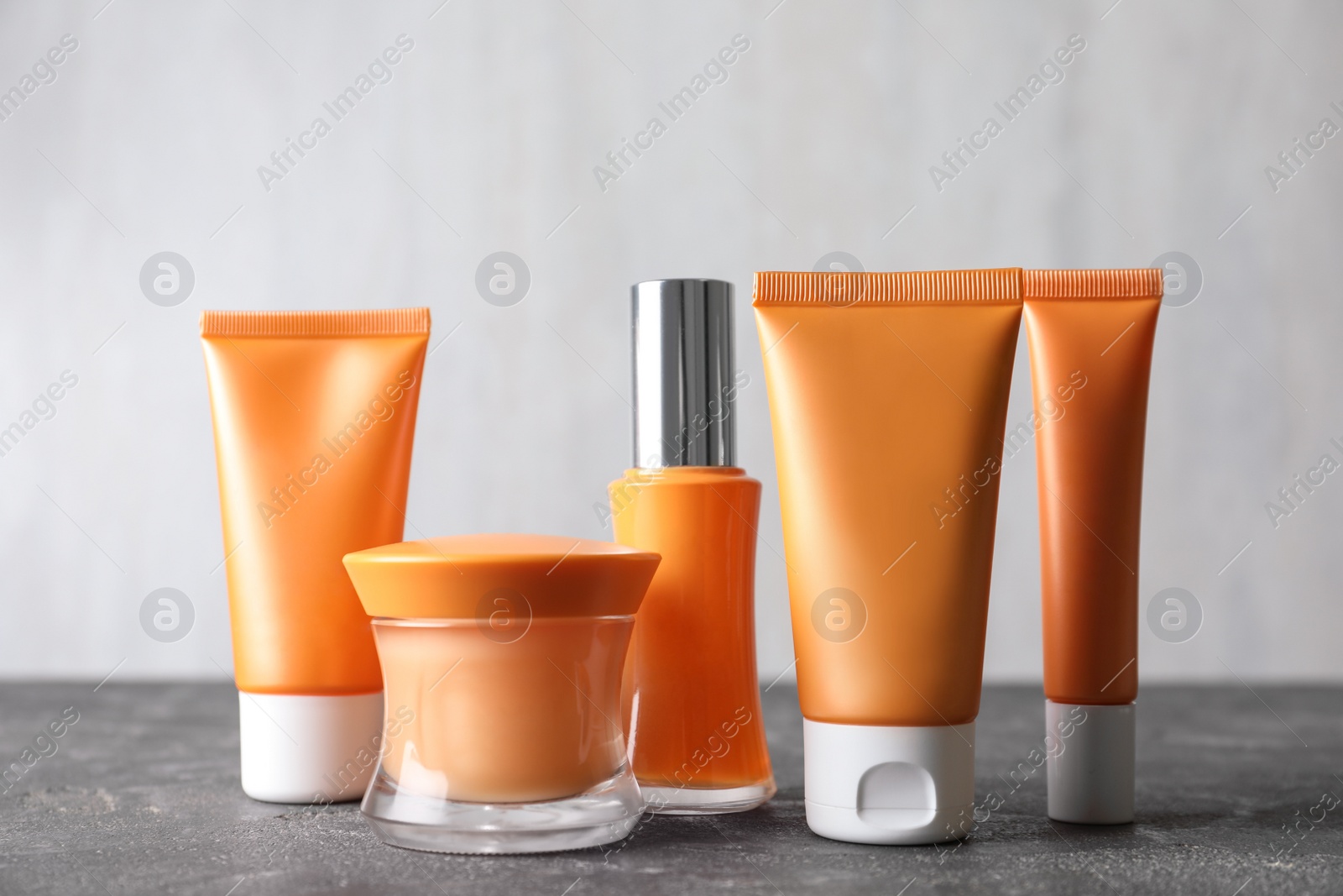 Photo of Set of luxury cosmetic products on grey table