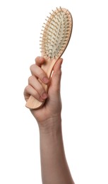 Photo of Woman holding bamboo hairbrush on white background, closeup. Conscious consumption