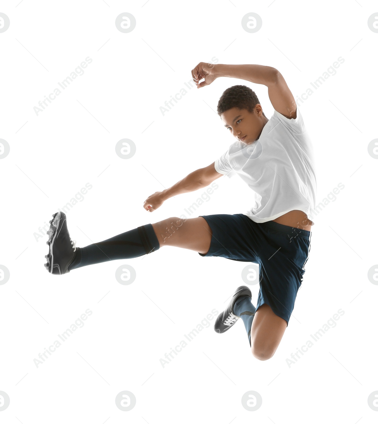 Photo of Teenage African-American boy playing football on white background