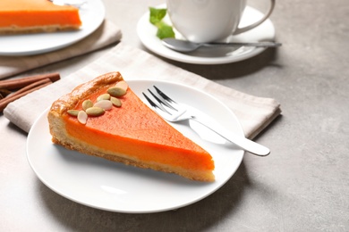 Plate with piece of fresh delicious homemade pumpkin pie on light table