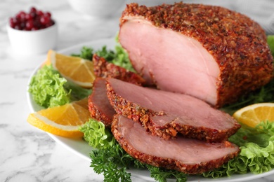 Plate with homemade delicious ham on marble table, closeup. Festive dinner