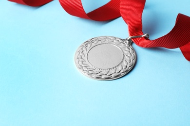 Photo of Gold medal with space for design on color background. Victory concept