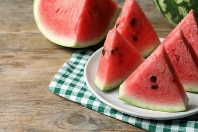 Photo of Delicious fresh watermelon slices on wooden table, closeup. Space for text