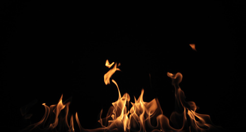 Photo of Beautiful bright fire flames on black background