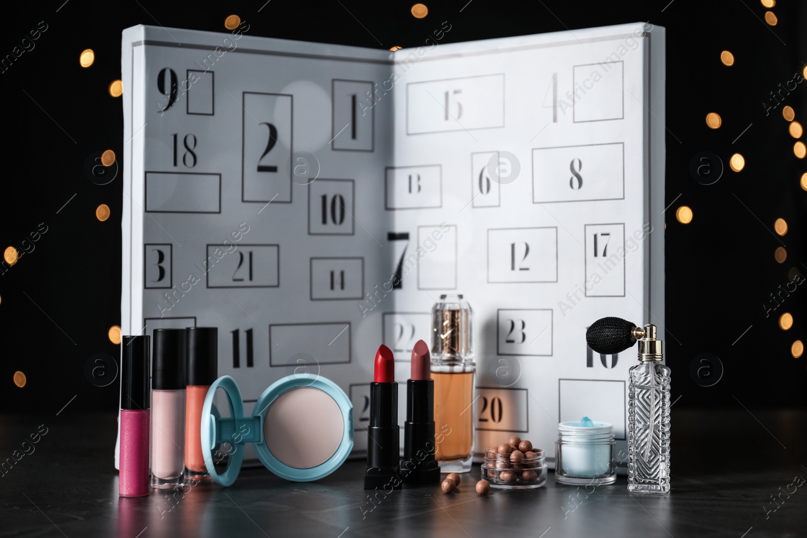 Christmas advent calendar with perfumes, skin care and decorative cosmetics on table Photo of Christmas advent calendar with perfumes, skin care and decorative cosmetics on table