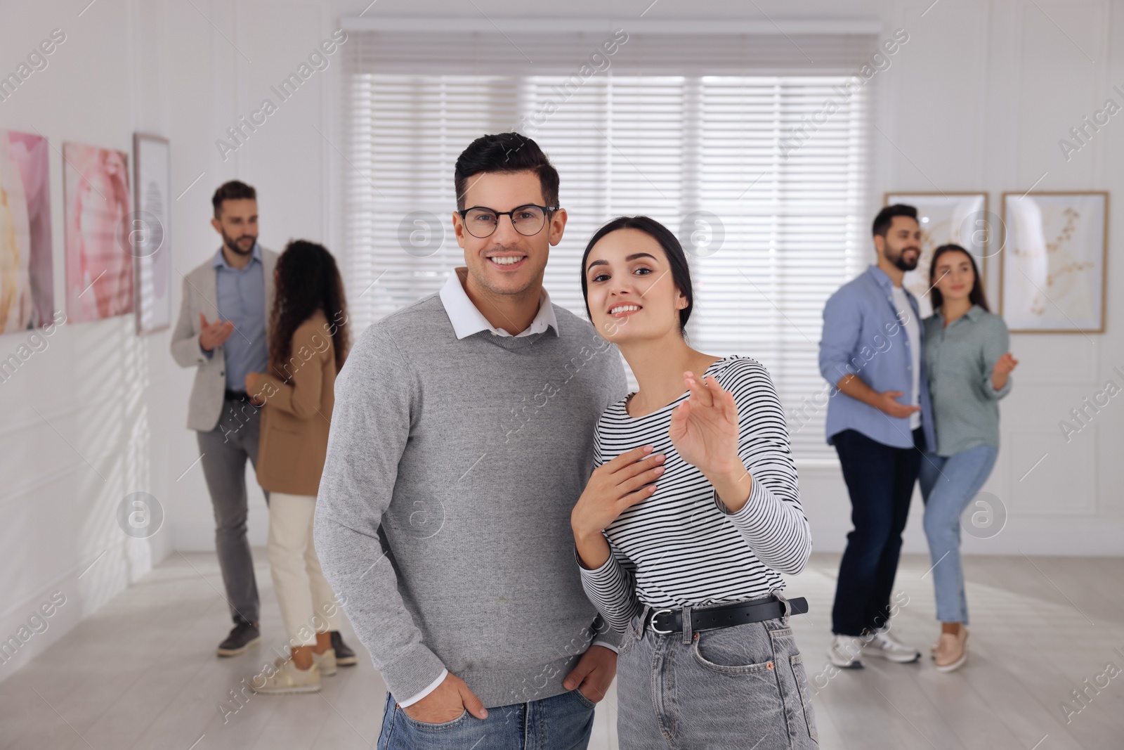 Photo of Happy couple at exhibition in art gallery