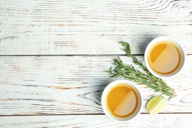 Photo of Flat lay composition with fresh rosemary oil on wooden background