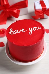 Bento cake with text Love You and gift boxes on white wooden table, closeup. St. Valentine's day surprise