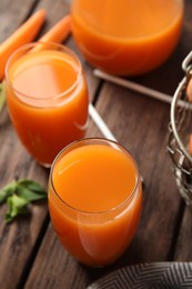 Photo of Freshly made carrot juice on wooden table