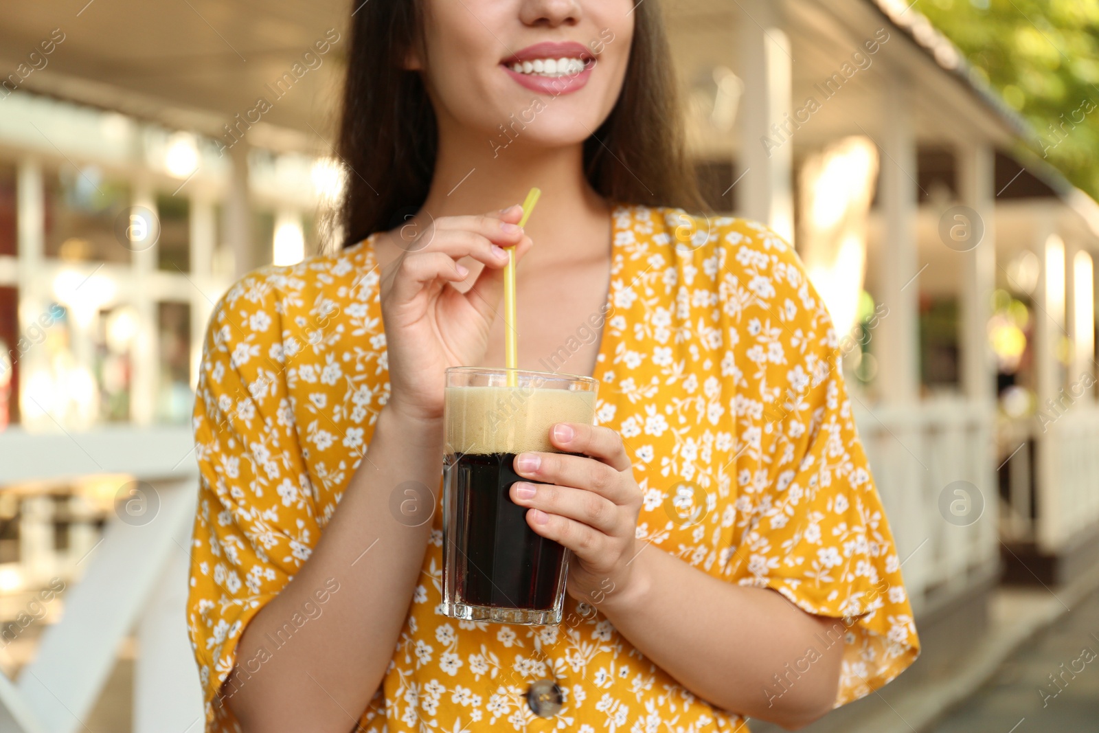 Photo of Young woman with cold kvass outdoors, closeup. Traditional Russian summer drink