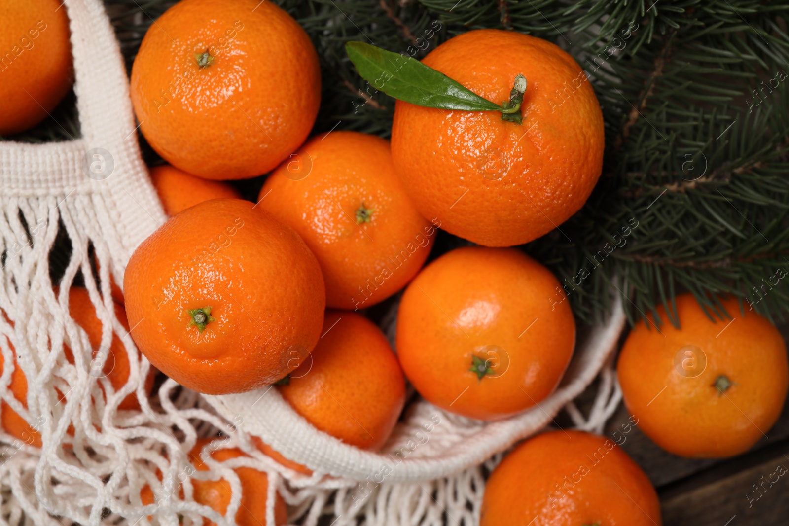 Photo of Fresh ripe tangerines on wooden table, above view