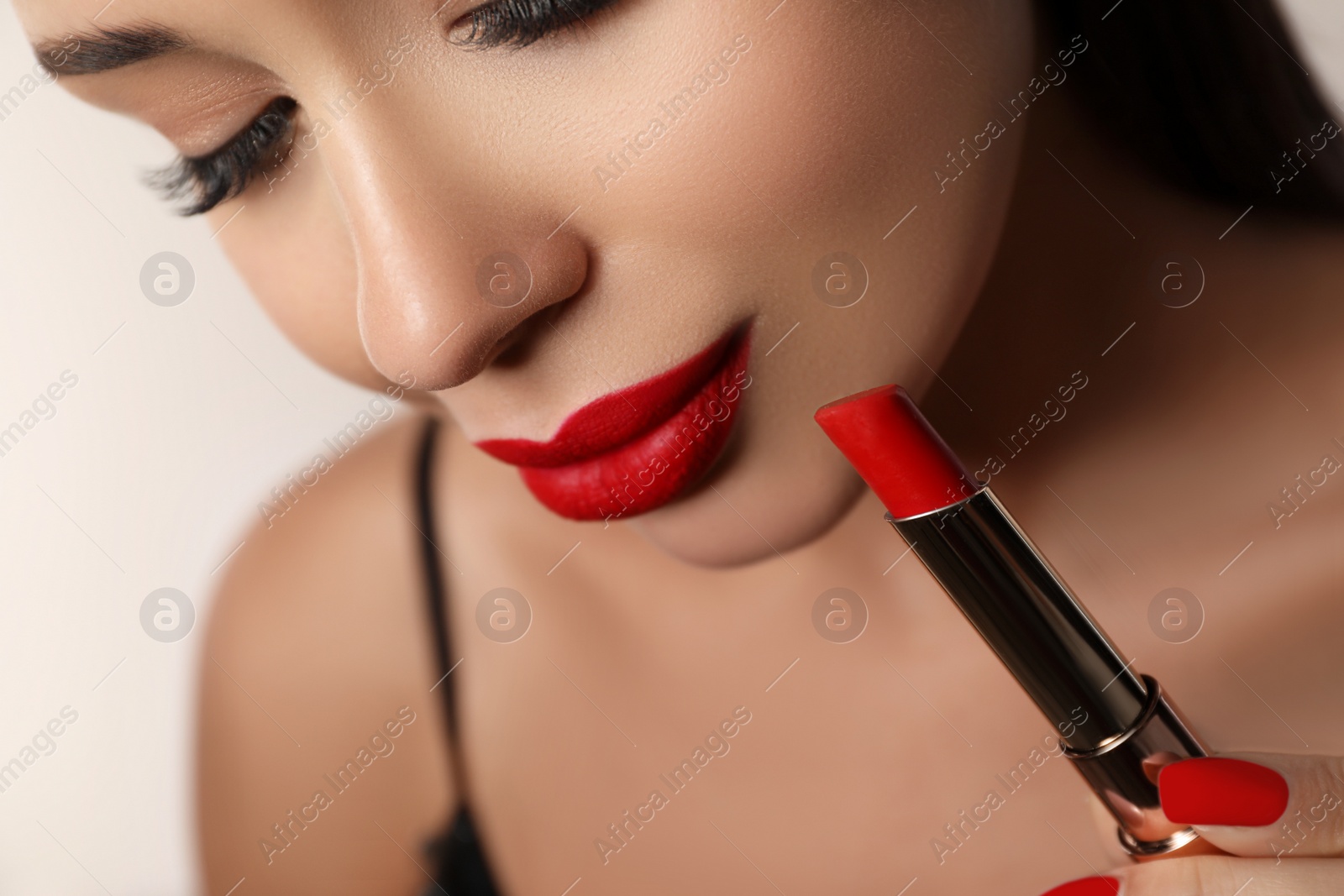 Photo of Beautiful woman with red lipstick on light background, closeup